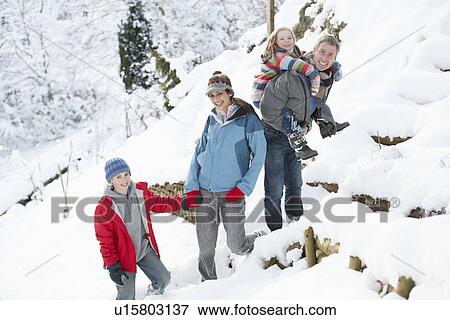 Family Enjoying Walk Through Snowy Landscape View Large Photo Image Stock Photo - Family Enjoying Walk Through Snowy Landscape. Fotosearch