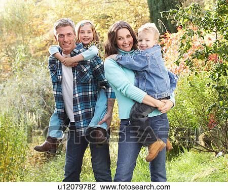Family Group Outdoors In Autumn Landscape With Parents Giving Chiildren Piggyback View Large Photo Image Stock Image - Family Group Outdoors In Autumn Landscape With Parents Giving Chiildren Piggyback. Fotosearch