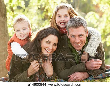 Family Group Relaxing Outdoors In Autumn Landscape View Large Photo Image Picture - Family Group Relaxing Outdoors In Autumn Landscape. Fotosearch