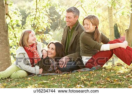 Picture - Family Group Relaxing Outdoors In Autumn Landscape. Fotosearch