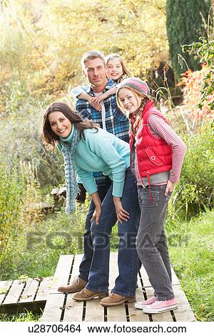 Family Group Standing Outdoors On Wooden Walkway In Autumn Landscape View Large Photo Image Picture - Family Group Standing Outdoors On Wooden Walkway In Autumn Landscape. Fotosearch