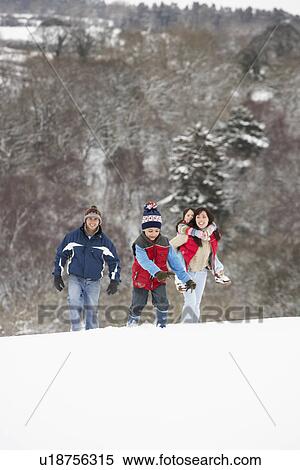 Family Having Fun In Snowy Countryside View Large Photo Image Stock Photography - Family Having Fun In Snowy Countryside. Fotosearch