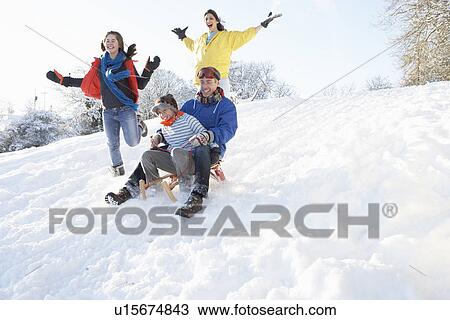 Family Having Fun Sledging Down Snowy Hill View Large Photo Image Stock Image - Family Having Fun Sledging Down Snowy Hill. Fotosearch