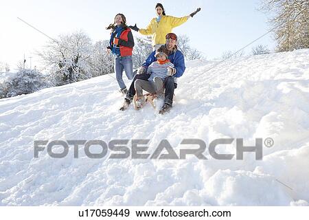 Family Having Fun Sledging Down Snowy Hill View Large Photo Image Stock Photo - Family Having Fun Sledging Down Snowy Hill. Fotosearch