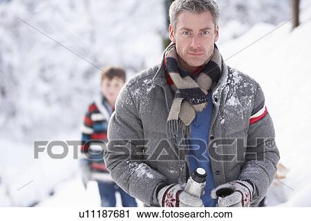 Family Stopping For Hot Drink And Snack On Walk Through Snowy Landscape View Large Photo Image Stock Image - Family Stopping For Hot Drink And Snack On Walk Through Snowy Landscape. Fotosearch