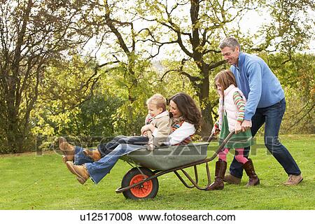 Family With Man Giving Mother And Children Ride In Wheelbarrow View Large Photo Image Stock Photo - Family With Man Giving Mother And Children Ride In Wheelbarrow. Fotosearch