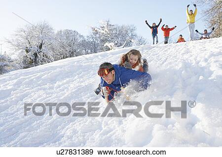 Stock Photo - Father And Daughter Having Fun Sledging Down Hill. Fotosearch