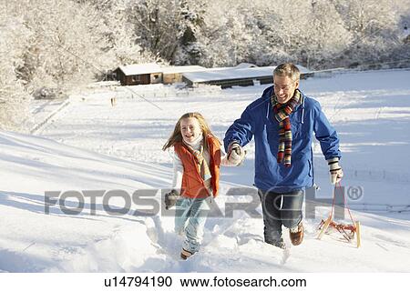 Father And Daughter Pulling Sledge Up Snowy Hill View Large Photo Image Stock Image - Father And Daughter Pulling Sledge Up Snowy Hill. Fotosearch