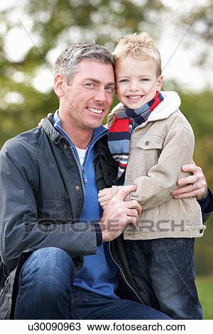 Stock Image - Father And Son Hugging On Outdoor Autumn Walk. Fotosearch