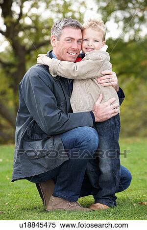 Father And Son Hugging On Outdoor Autumn Walk View Large Photo Image Stock Photography - Father And Son Hugging On Outdoor Autumn Walk. Fotosearch