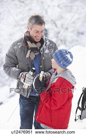 Father And Son Stopping For Hot Drink And Snack On Walk Through Snowy Landscape View Large Photo Image Stock Image - Father And Son Stopping For Hot Drink And Snack On Walk Through Snowy Landscape. Fotosearch