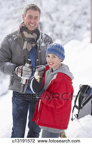 Father And Son Stopping For Hot Drink And Snack On Walk Through Snowy Landscape View Large Photo Image Stock Image - Father And Son Stopping For Hot Drink And Snack On Walk Through Snowy Landscape. Fotosearch