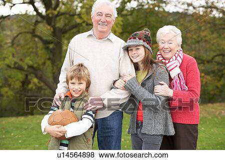 Grandparents With Grandchildren Holding Football Outside View Large Photo Image Stock Photo - Grandparents With Grandchildren Holding Football Outside. Fotosearch