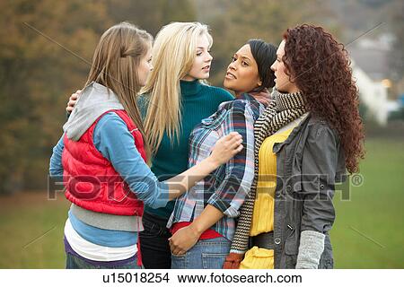 Picture - Group Of Female Teenagers Bullying Girl. Fotosearch