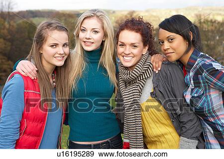 Group Of Four Teenage Female Friends In Autumn Landscape View Large Photo Image Stock Photo - Group Of Four Teenage Female Friends In Autumn Landscape. Fotosearch