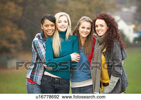 Stock Image - Group Of Four Teenage Girls In Autumn Landscape. Fotosearch