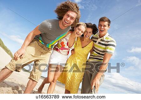 Stock Photo - Group Of Friends Having Fun On Summer Beach. Fotosearch