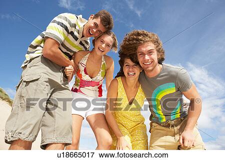 Stock Photo - Group Of Friends Having Fun On Summer Beach. Fotosearch