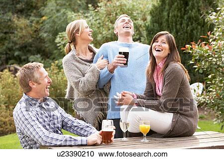 Group Of Friends Outdoors Enjoying Drink In Pub Garden View Large Photo Image Stock Image - Group Of Friends Outdoors Enjoying Drink In Pub Garden. Fotosearch