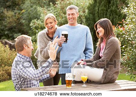 Group Of Friends Outdoors Enjoying Drink In Pub Garden View Large Photo Image Stock Photo - Group Of Friends Outdoors Enjoying Drink In Pub Garden. Fotosearch