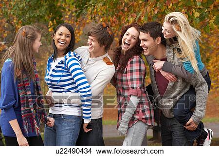 Group Of Six Teenage Friends Having Fun In Autumn Park View Large Photo Image Picture - Group Of Six Teenage Friends Having Fun In Autumn Park. Fotosearch