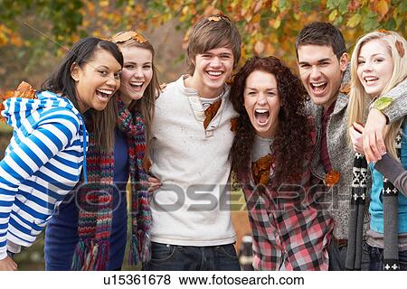 Group Of Six Teenage Friends Having Fun In Autumn Park View Large Photo Image Stock Photo - Group Of Six Teenage Friends Having Fun In Autumn Park. Fotosearch