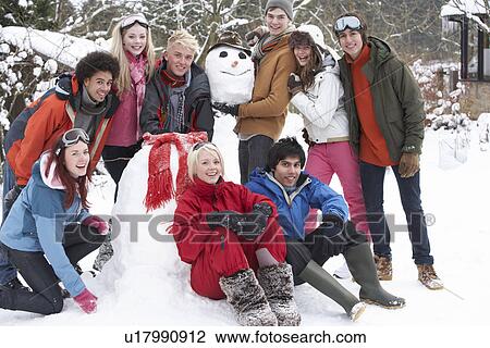 Group Of Teenage Friends Building Snowman In Garden View Large Photo Image Stock Image - Group Of Teenage Friends Building Snowman In Garden. Fotosearch