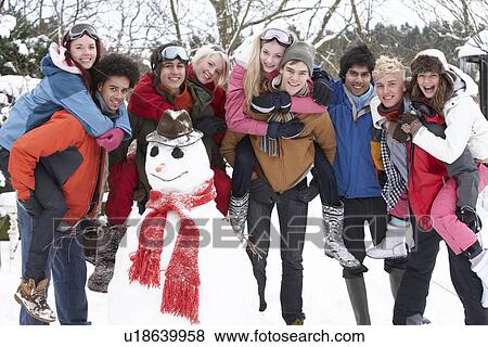 Group Of Teenage Friends Building Snowman In Garden View Large Photo Image Stock Photo - Group Of Teenage Friends Building Snowman In Garden. Fotosearch