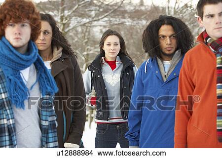 Picture - Group Of Teenage Friends Having Fun In Snowy Landscape Wearing Ski Clothing. Fotosearch