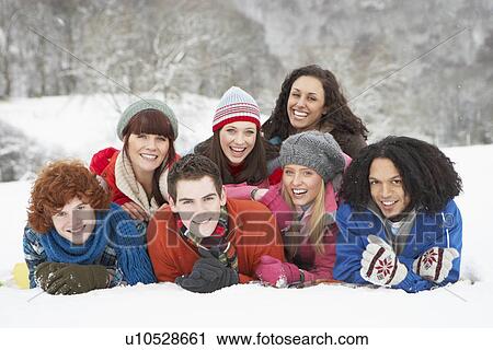 Stock Image - Group Of Teenage Friends Having Fun In Snowy Landscape. Fotosearch