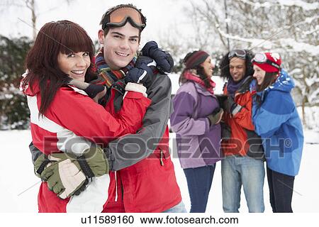 Stock Image - Group Of Teenage Friends Having Fun In Snowy Landscape Wearing Ski Clothing. Fotosearch