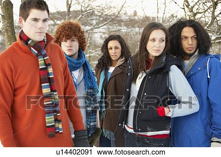 Group Of Teenage Friends Having Fun In Snowy Landscape Wearing Ski Clothing View Large Photo Image Stock Image - Group Of Teenage Friends Having Fun In Snowy Landscape Wearing Ski Clothing. Fotosearch