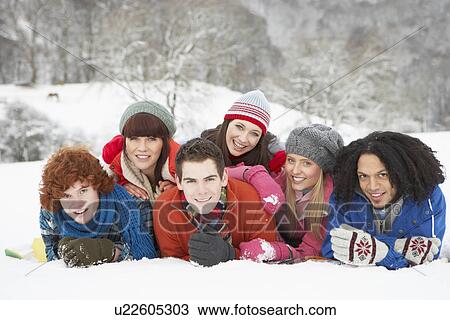Stock Image - Group Of Teenage Friends Having Fun In Snowy Landscape. Fotosearch