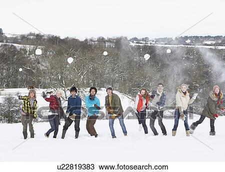 Stock Image - Group Of Teenage Friends Having Fun In Snowy Landscape. Fotosearch