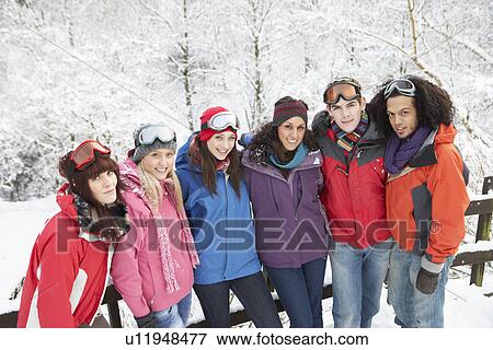 Group Of Teenage Friends Having Fun In Snowy Landscape Wearing Ski Clothing View Large Photo Image Stock Photo - Group Of Teenage Friends Having Fun In Snowy Landscape Wearing Ski Clothing. Fotosearch