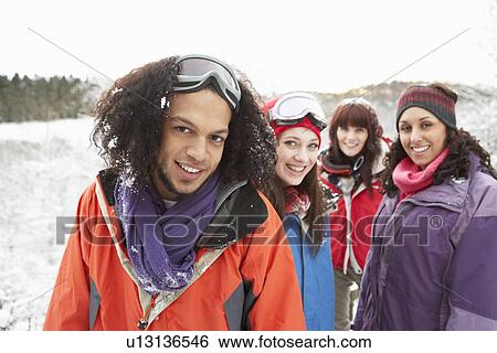 Group Of Teenage Friends Having Fun In Snowy Landscape Wearing Ski Clothing View Large Photo Image Stock Photograph - Group Of Teenage Friends Having Fun In Snowy Landscape Wearing Ski Clothing. Fotosearch