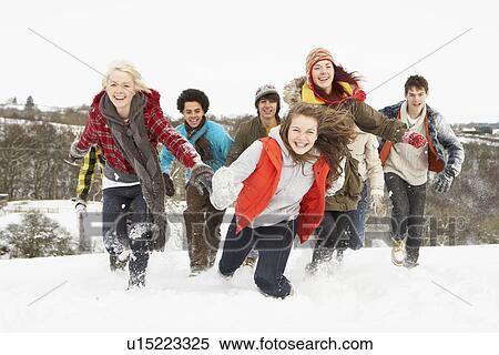 Stock Photography - Group Of Teenage Friends Having Fun In Snowy Landscape. Fotosearch