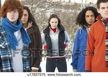 Stock Photography - Group Of Teenage Friends Having Fun In Snowy Landscape Wearing Ski Clothing. Fotosearch