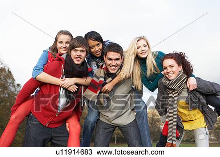Group Of Teenage Friends Having Piggyback Rides In Autumn Landscape View Large Photo Image Stock Image - Group Of Teenage Friends Having Piggyback Rides In Autumn Landscape. Fotosearch