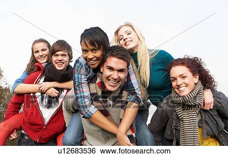 Group Of Teenage Friends Having Piggyback Rides In Autumn Landscape View Large Photo Image Stock Photograph - Group Of Teenage Friends Having Piggyback Rides In Autumn Landscape. Fotosearch