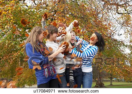 Group Of Teenage Friends Throwing Leaves In Autumn Landscape View Large Photo Image Stock Image - Group Of Teenage Friends Throwing Leaves In Autumn Landscape. Fotosearch