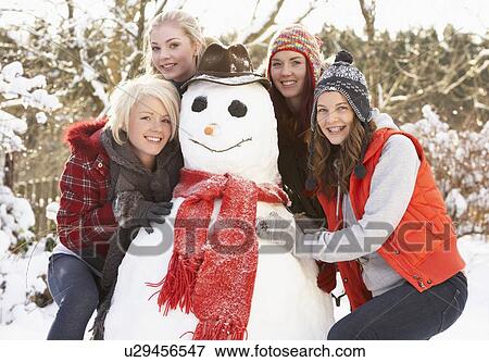 Group Of Teenage Girls Building Snowman View Large Photo Image Stock Photo - Group Of Teenage Girls Building Snowman. Fotosearch