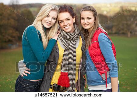 Group Of Three Teenage Female Friends In Autumn Landscape View Large Photo Image Stock Image - Group Of Three Teenage Female Friends In Autumn Landscape. Fotosearch