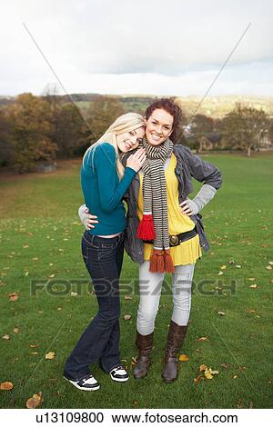 Group Of Two Teenage Female Friends In Autumn Landscape View Large Photo Image Stock Image - Group Of Two Teenage Female Friends In Autumn Landscape. Fotosearch