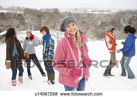 Stock Photo - Group Of Young Friends Having Fun In Snowy Landscape. Fotosearch