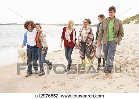 Group Of Young Friends Walking Along Autumn Shoreline View Large Photo Image Stock Image - Group Of Young Friends Walking Along Autumn Shoreline. Fotosearch
