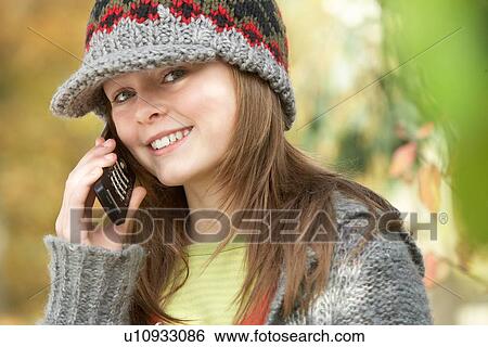 Head And Shoulders Of Young Girl In Autumn Woodland Using Mobile Phone View Large Photo Image Stock Photograph - Head And Shoulders Of Young Girl In Autumn Woodland Using Mobile Phone. Fotosearch