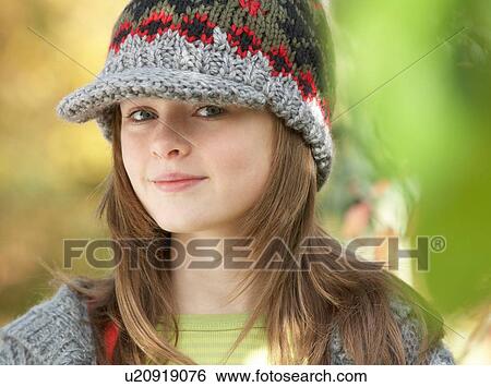Stock Photograph - Head And Shoulders Of Young Girl In Autumn Woodland. Fotosearch