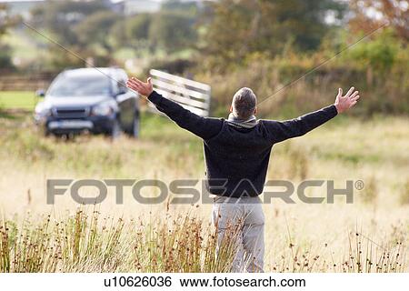 Man Enjoying Freedom Outdoors in Autumn Landscape View Large Photo Image Stock Photograph - Man Enjoying Freedom Outdoors in Autumn Landscape. Fotosearch