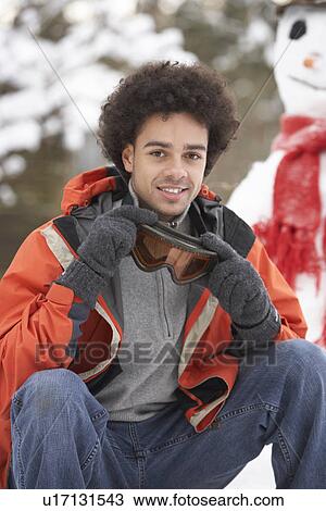 Stock Image - Man Wearing Winter Clothes In Snowy Landscape. Fotosearch